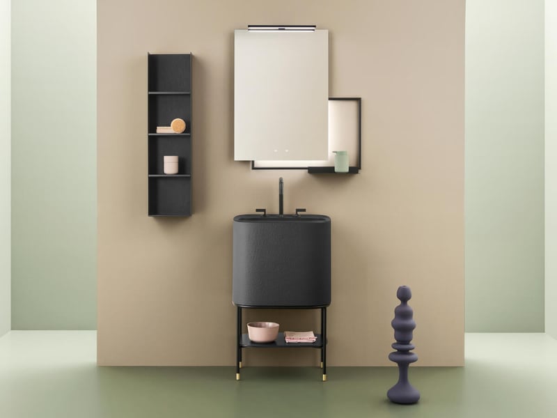 Illuminated vanity mirror and a pedestal sink in a compact powder room